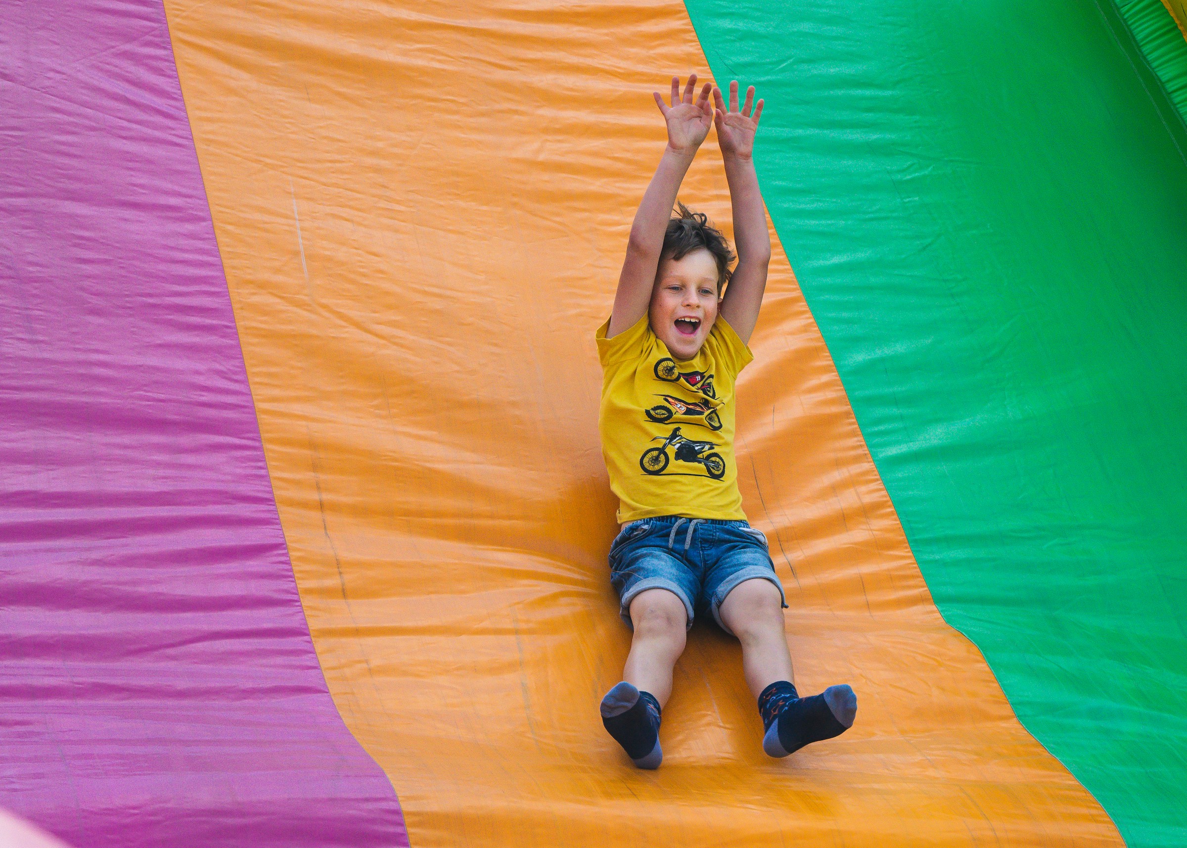 A boy slides down an inflatable slide