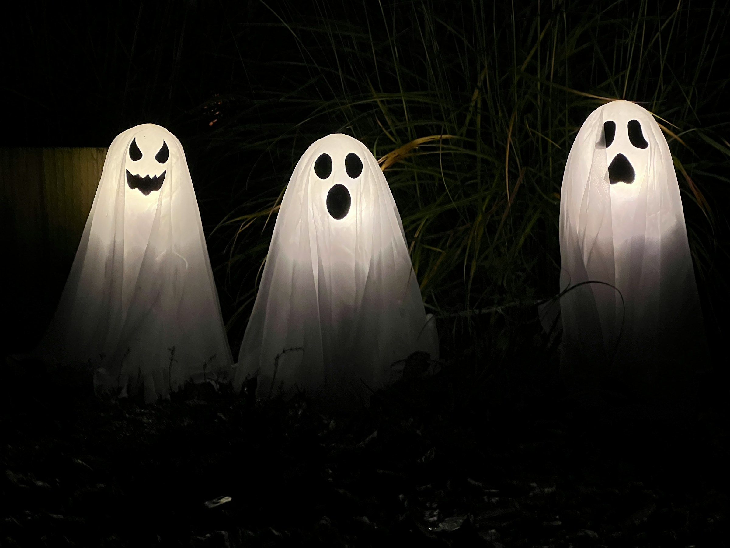 Three classic ghosts float wit a forest behind them